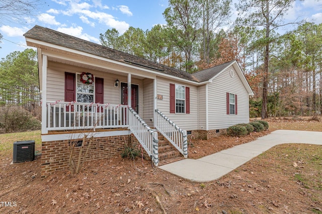 single story home featuring covered porch and central air condition unit