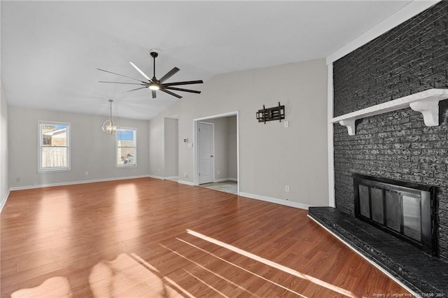 5814 Valhalla Ct, Fayetteville, NC 28304 - unfurnished living room with a large fireplace, wood finished floors, a ceiling fan, lofted ceiling, and baseboards