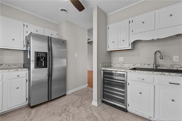 5814 Valhalla Ct, Fayetteville, NC 28304 - kitchen with stainless steel fridge, beverage cooler, a sink, white cabinetry, and ceiling fan