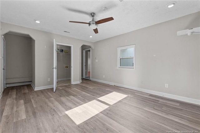 5814 Valhalla Ct, Fayetteville, NC 28304 - unfurnished bedroom with arched walkways, light wood finished floors, baseboards, a walk in closet, and recessed lighting