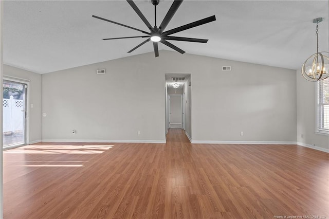 5814 Valhalla Ct, Fayetteville, NC 28304 - unfurnished living room with lofted ceiling, plenty of natural light, a chandelier, and light wood-style flooring