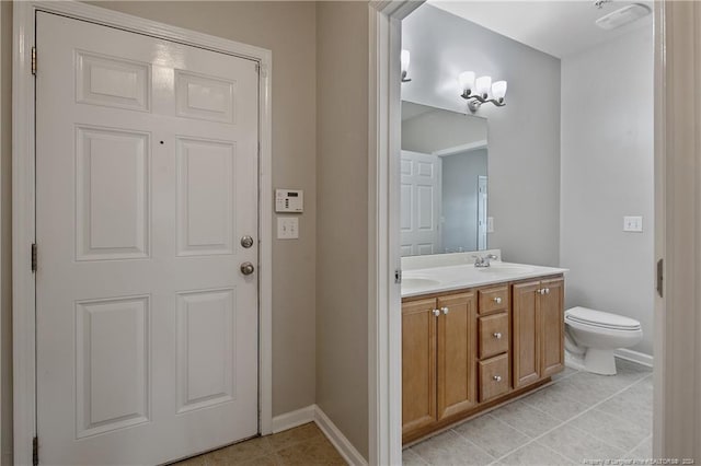 bathroom with tile patterned flooring, vanity, and toilet