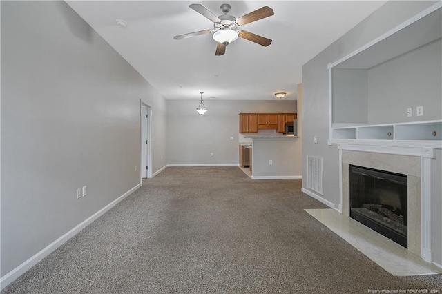 unfurnished living room featuring ceiling fan and light carpet