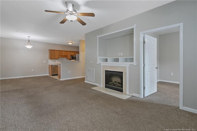 unfurnished living room featuring light carpet and ceiling fan