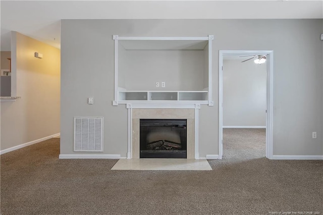 unfurnished living room featuring carpet floors and ceiling fan