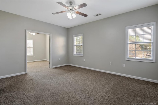 empty room featuring carpet flooring and ceiling fan