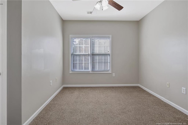 spare room with carpet and ceiling fan