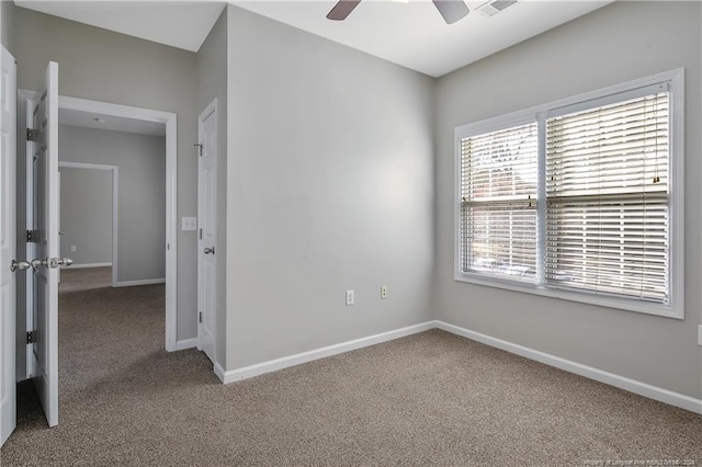 empty room featuring carpet flooring and ceiling fan