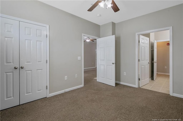 unfurnished bedroom featuring ceiling fan, light colored carpet, and a closet