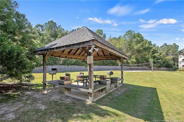 view of community featuring a gazebo, a lawn, and volleyball court