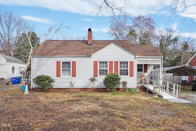 view of front of house featuring central AC unit and a carport