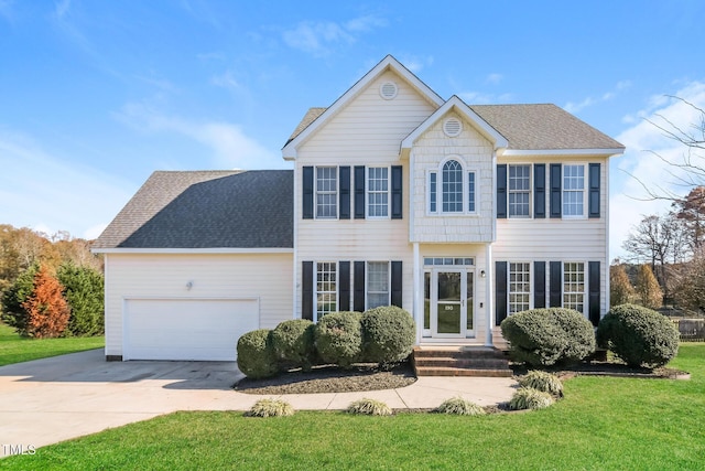 colonial inspired home featuring a front lawn and a garage