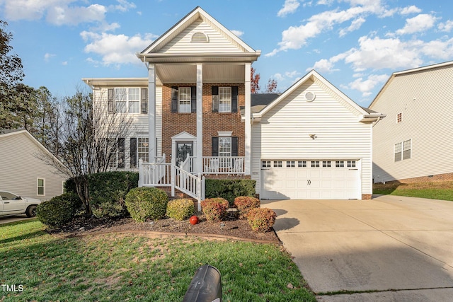 view of front of property featuring a garage and a front lawn