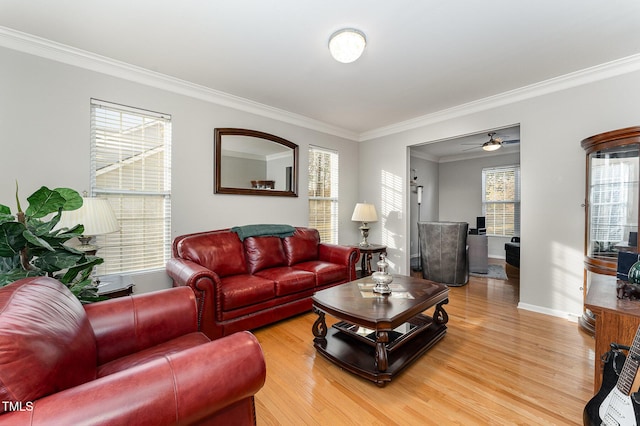 living room featuring hardwood / wood-style flooring, ceiling fan, crown molding, and a wealth of natural light