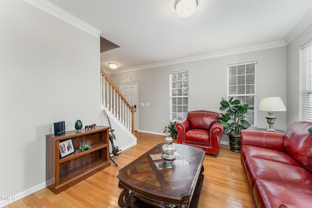 living room with wood-type flooring and ornamental molding