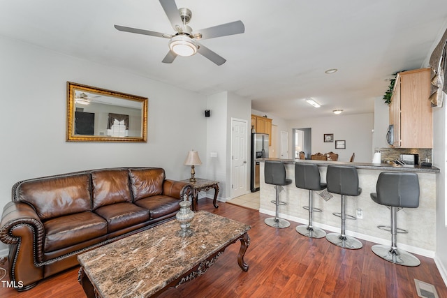 living room with light wood-type flooring and ceiling fan