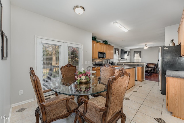 dining room featuring ceiling fan and light tile patterned flooring