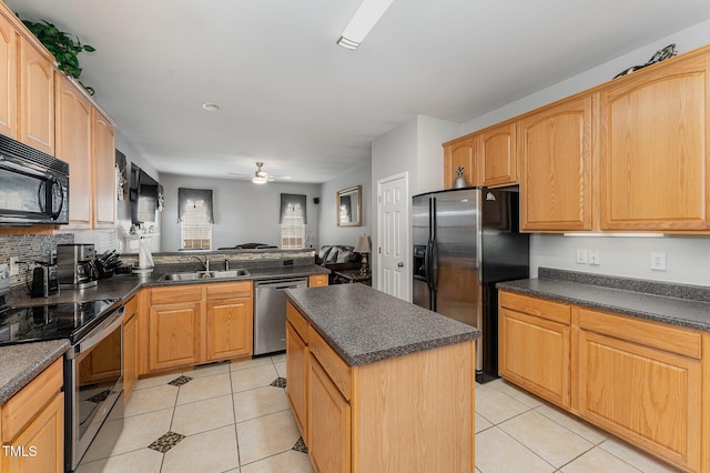 kitchen featuring ceiling fan, a center island, sink, stainless steel appliances, and light tile patterned flooring