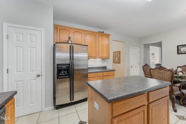 kitchen with light tile patterned floors, stainless steel appliances, and a kitchen island