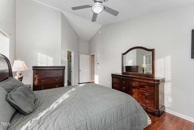 bedroom with ceiling fan, dark hardwood / wood-style flooring, and high vaulted ceiling