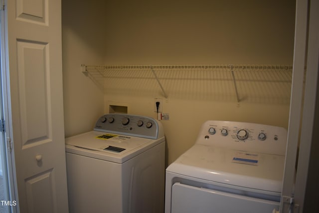 laundry area with washing machine and clothes dryer