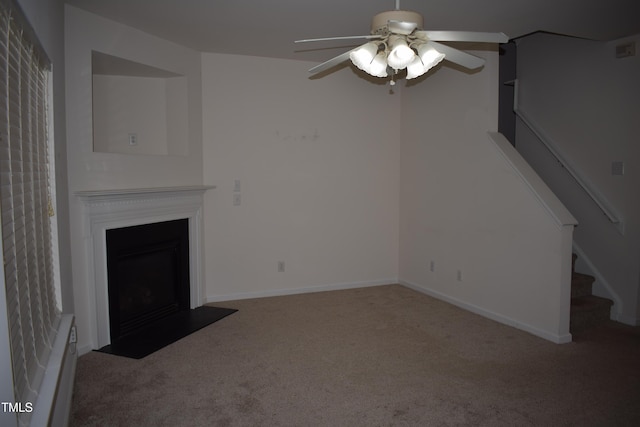 unfurnished living room featuring ceiling fan and carpet floors