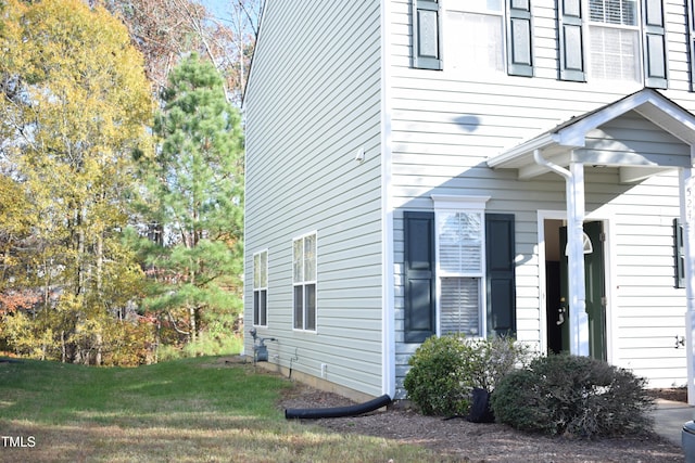 view of property exterior featuring a lawn