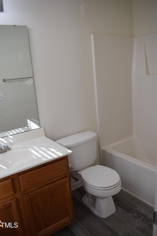 full bathroom featuring wood-type flooring, vanity, toilet, and shower / washtub combination