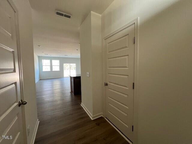 hall with dark hardwood / wood-style flooring