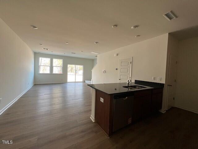 kitchen with wood-type flooring, dishwasher, sink, and dark brown cabinets