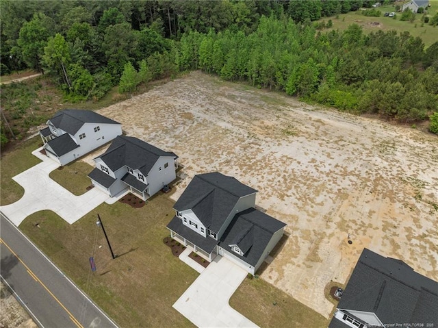 aerial view featuring a wooded view