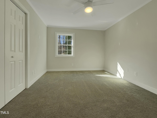 unfurnished bedroom with carpet flooring, ceiling fan, a closet, and crown molding