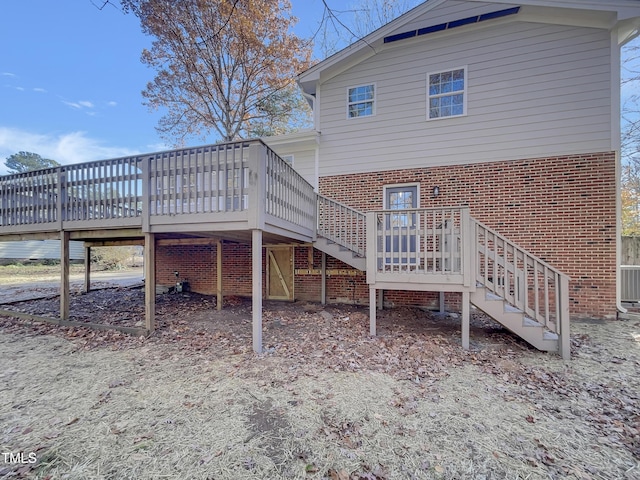 back of property featuring a deck and central AC unit