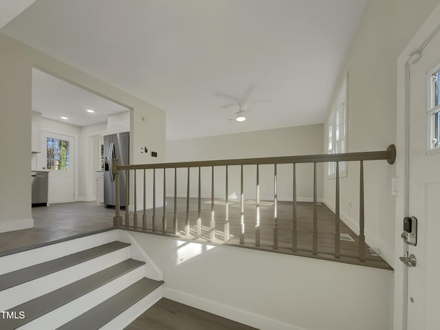 stairway featuring hardwood / wood-style flooring and ceiling fan