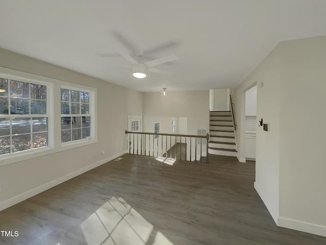 empty room featuring ceiling fan and dark hardwood / wood-style flooring