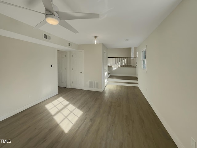 spare room with ceiling fan and dark wood-type flooring