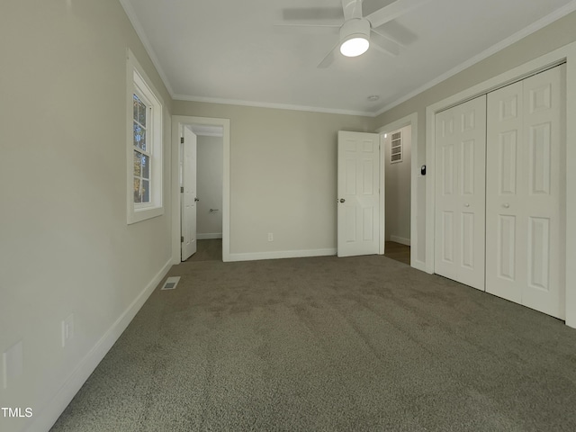 unfurnished bedroom with ceiling fan, a closet, carpet floors, and ornamental molding