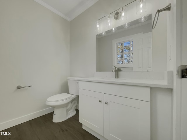 bathroom with vanity, hardwood / wood-style flooring, toilet, and crown molding