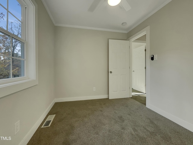 carpeted empty room with ceiling fan and crown molding