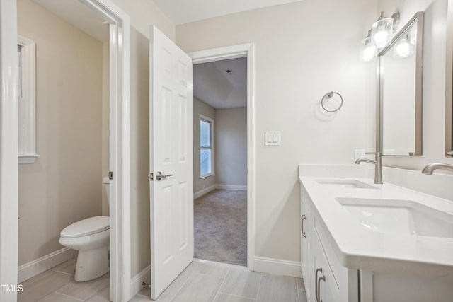 bathroom with tile patterned floors, vanity, and toilet