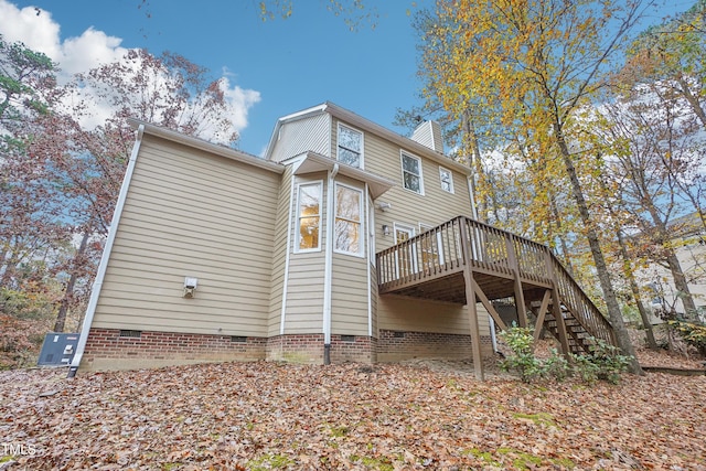 back of property featuring a wooden deck