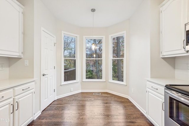 unfurnished dining area with dark hardwood / wood-style flooring