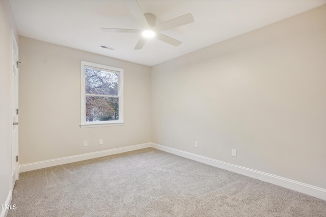 spare room featuring carpet and ceiling fan