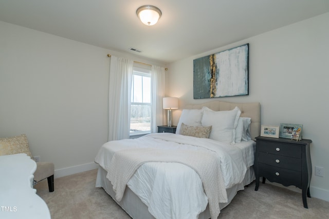 bedroom featuring light colored carpet, visible vents, and baseboards