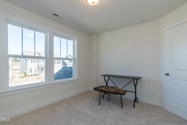 carpeted home office with baseboards and visible vents