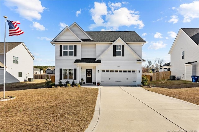 view of front of house featuring a garage, a front lawn, and central AC unit