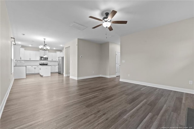 unfurnished living room with hardwood / wood-style floors, ceiling fan with notable chandelier, and sink