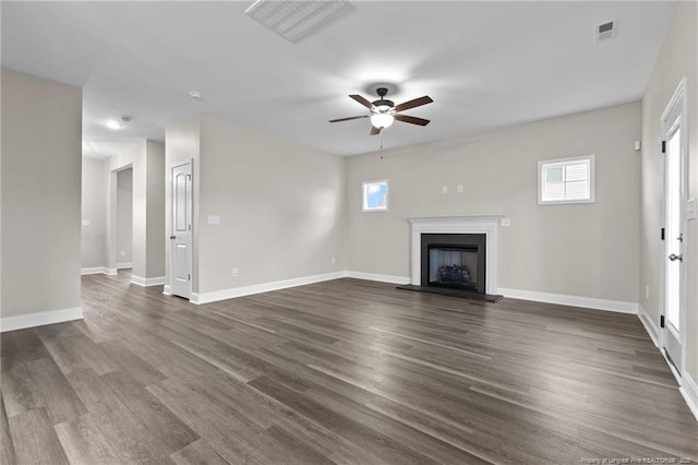 unfurnished living room with dark wood-type flooring and ceiling fan