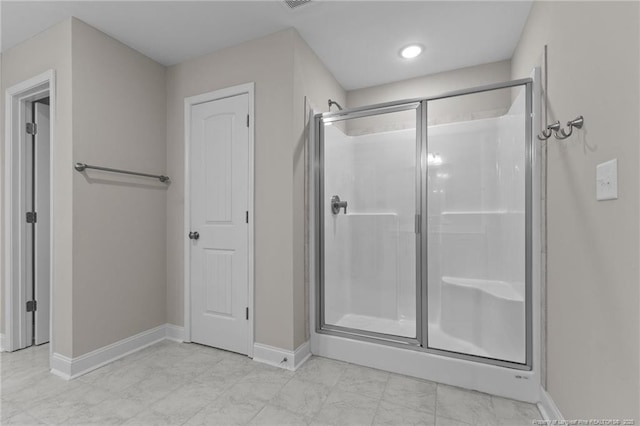 bathroom featuring a shower with shower door