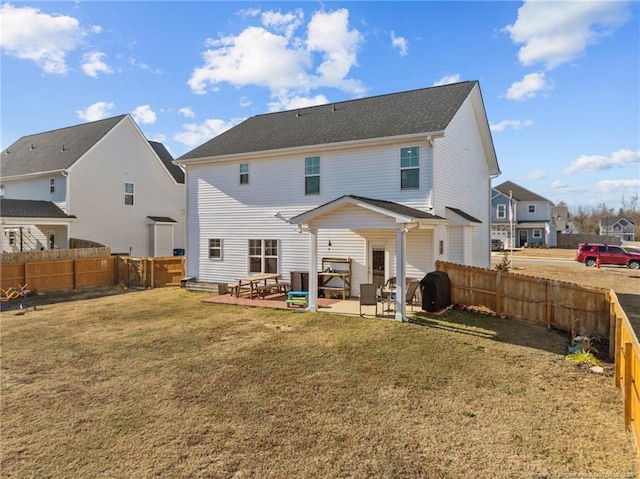 rear view of house with a patio area and a lawn